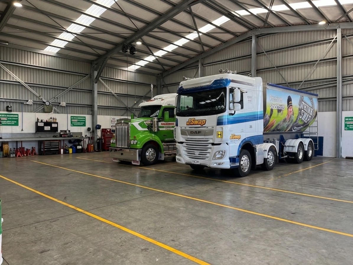 Trucks in for service inside the Egmont Diesel Services workshop in Inglewood, Taranaki